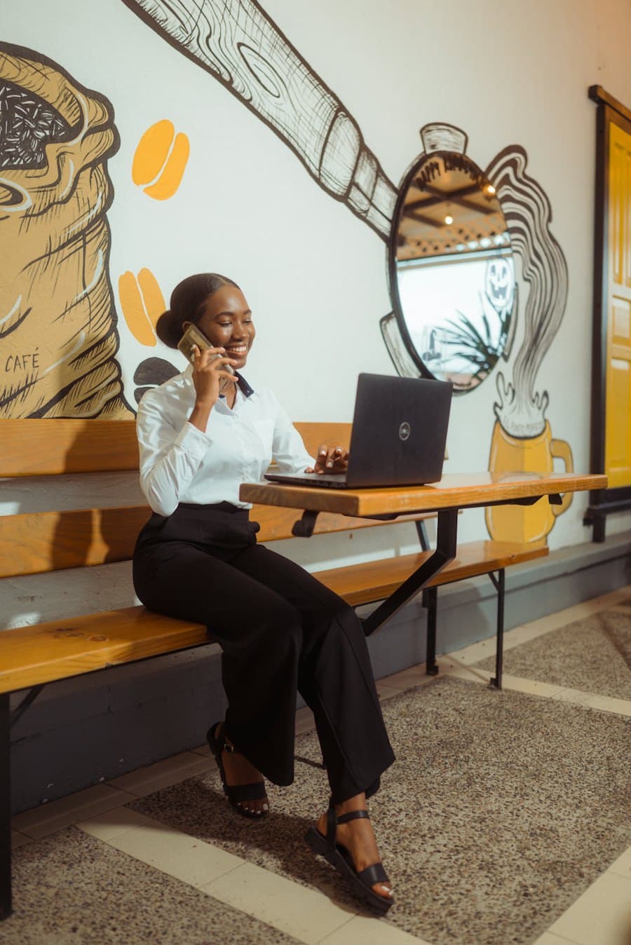 Business owner on the phone while working on a laptop